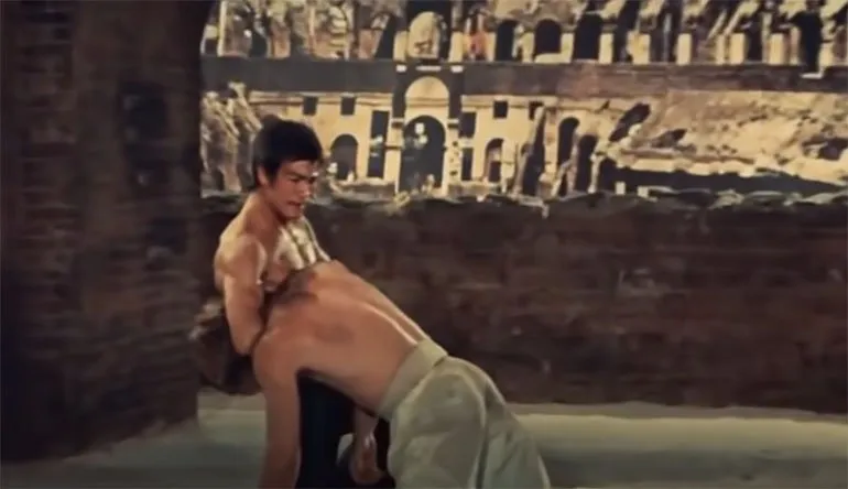 Bruce Lee performing a standing guillotine against Chuck Norris in the 1972 movie “Way of the Dragon.”